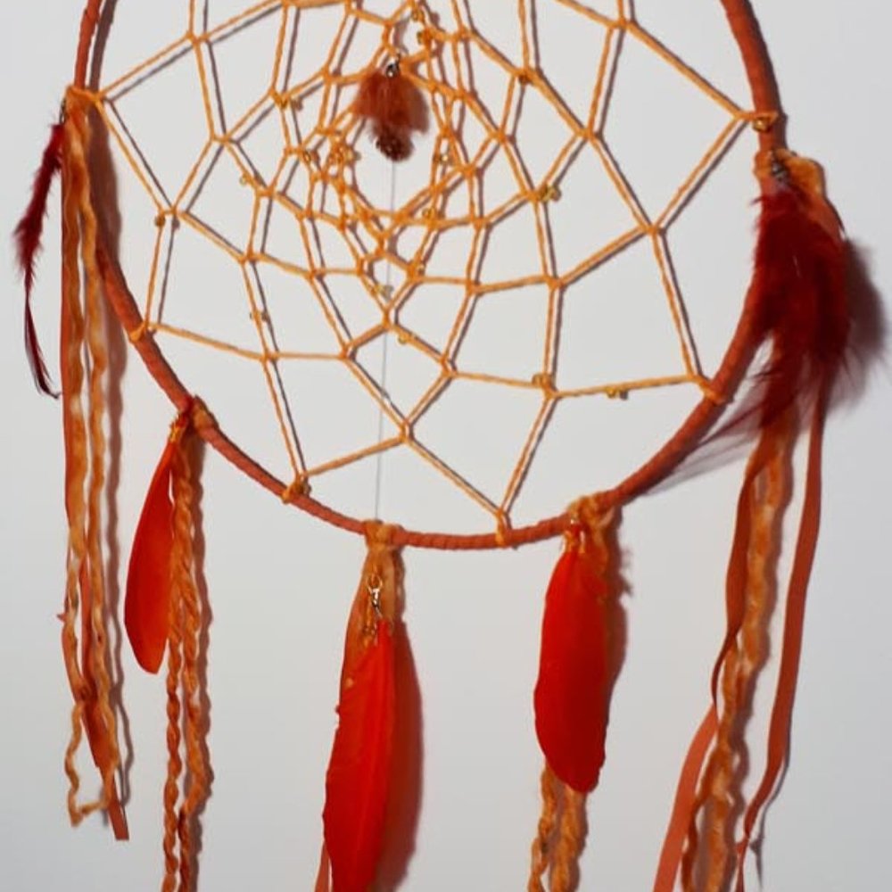 Dreamcatcher in orange and reds.